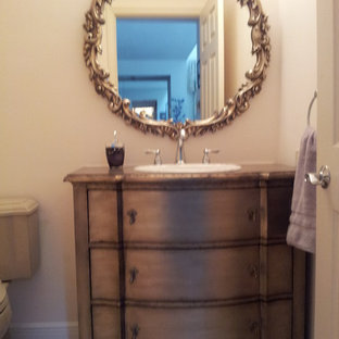 Inspiration for a mid-sized timeless 3/4 travertine floor alcove shower remodel in Tampa with flat-panel cabinets, distressed cabinets, a two-piece toilet, an undermount sink and copper countertops