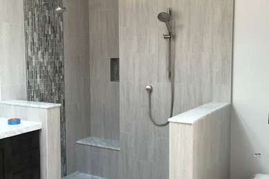 Transitional bathroom in San Francisco with shaker cabinets, a freestanding tub, a double shower, a wall-mount toilet, white tile, porcelain tile, grey walls, porcelain floors, an undermount sink and marble benchtops.