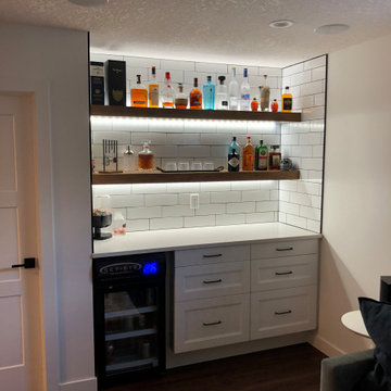 bar area with customizable LED lighting in oak shelving