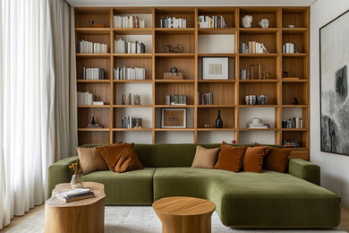 This is an example of a medium sized modern living room in London with white walls, light hardwood flooring, a freestanding tv and a drop ceiling.
