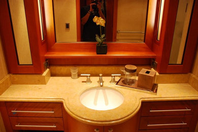 Example of a huge trendy master marble floor drop-in bathtub design in New Orleans with marble countertops