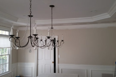 Mid-sized elegant dark wood floor enclosed dining room photo in New York with beige walls