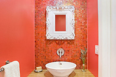 Example of a small trendy red tile and mosaic tile mosaic tile floor powder room design in San Francisco with open cabinets, medium tone wood cabinets, red walls, a vessel sink, wood countertops, brown countertops and a built-in vanity
