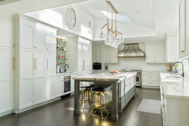Example of a large transitional u-shaped medium tone wood floor, brown floor and coffered ceiling eat-in kitchen design in New York with a drop-in sink, shaker cabinets, white cabinets, quartzite countertops, yellow backsplash, glass tile backsplash, paneled appliances, an island and white countertops