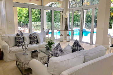 Family room - large contemporary open concept marble floor and beige floor family room idea in New York