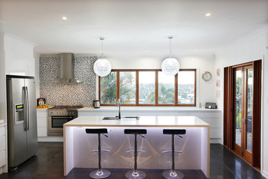 Inspiration for a large contemporary u-shaped eat-in kitchen in Brisbane with an undermount sink, white cabinets, quartz benchtops, metallic splashback, mosaic tile splashback, stainless steel appliances, porcelain floors and with island.