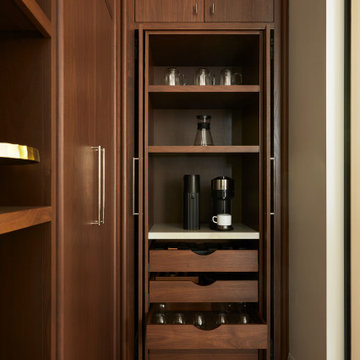 Walnut Pocket Doors Unveil a Stylish Kitchen Pantry Coffee Station