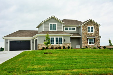 Inspiration for a large craftsman gray two-story mixed siding exterior home remodel in Kansas City with a hip roof