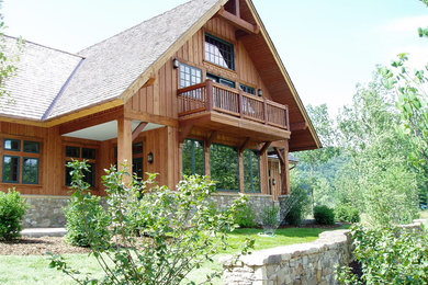 Large mountain style brown two-story wood exterior home photo in Charleston