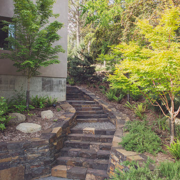 Ledgestone staircase with stacked basalt retaining walls and flagstone patio