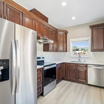Traditional English Walnut Kitchen Remodel with Raised Panel Cabinets and Quartz