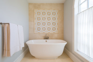 Design ideas for a large transitional master bathroom in Boston with flat-panel cabinets, dark wood cabinets, a freestanding tub, an alcove shower, a two-piece toilet, beige tile, stone tile, grey walls, marble floors and an integrated sink.