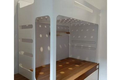 Inspiration for a large modern gender-neutral medium tone wood floor and brown floor kids' room remodel in New York with white walls