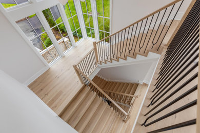Inspiration for a large contemporary wooden u-shaped mixed material railing staircase remodel in DC Metro with wooden risers