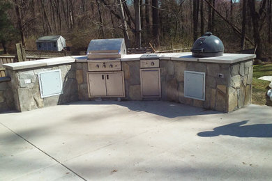 Large mountain style stone patio photo in Other