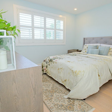 Bright Bedroom with Upholstered Bed and White Shutters | The Junction
