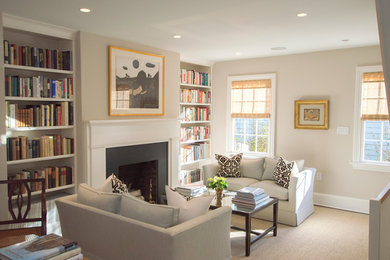 Example of a mid-sized classic enclosed medium tone wood floor and brown floor living room design in DC Metro with gray walls, a standard fireplace, a metal fireplace and no tv