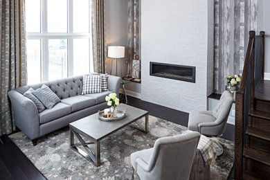 Inspiration for a transitional open concept dark wood floor, brown floor and wallpaper living room remodel in Ottawa with gray walls, a standard fireplace and a stacked stone fireplace