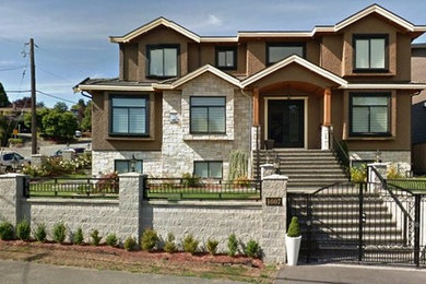 Example of a transitional home design design in Vancouver