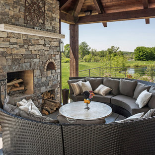 ミルウォーキーの中サイズのサンタフェスタイルのおしゃれな横庭のデッキ (ファイヤーピット、張り出し屋根) の写真