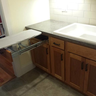 Inspiration for a small traditional galley utility room in Other with an utility sink, shaker cabinets, medium wood cabinets, laminate countertops and green worktops.