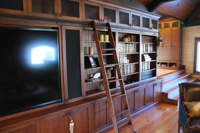 Example of a large classic open concept medium tone wood floor and brown floor living room design in Toronto with a concealed tv
