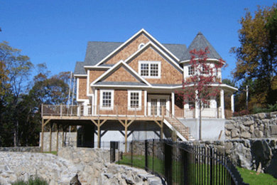 Inspiration for a mid-sized timeless beige two-story wood exterior home remodel in New York