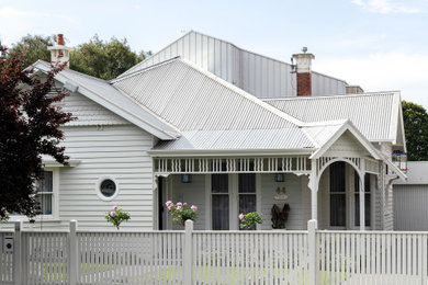 Design ideas for a large contemporary two-storey white house exterior in Geelong with metal siding, a gable roof, a metal roof and a white roof.