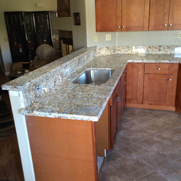 Kitchen cinnamon shaker cabinets with sparking quartz countertops
