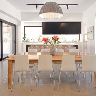 Photo of a large contemporary open plan dining in Geelong with concrete floors and grey floor.