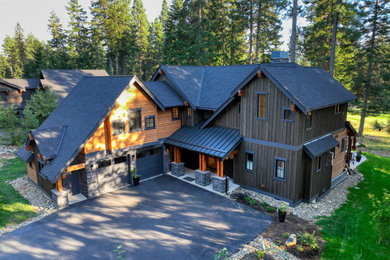 Inspiration for a mid-sized craftsman brown two-story wood and board and batten exterior home remodel in Seattle with a shingle roof and a black roof