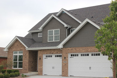 Inspiration for a mid-sized transitional gray two-story wood exterior home remodel in Chicago with a shingle roof