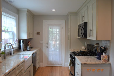Photo of a large traditional l-shaped kitchen in New York with shaker cabinets, beige cabinets, quartz benchtops and multi-coloured benchtop.