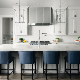 Transitional kitchen inspiration - Kitchen - transitional dark wood floor and brown floor kitchen idea in Boise with shaker cabinets, white cabinets, white backsplash, subway tile backsplash, stainless steel appliances, an island and gray countertops
