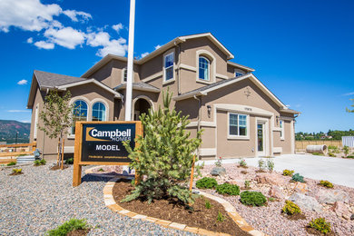 Mid-sized traditional beige two-story stucco exterior home idea in Denver
