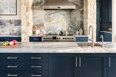 Example of a large transitional u-shaped ceramic tile and beige floor eat-in kitchen design in Austin with an undermount sink, shaker cabinets, blue cabinets, quartzite countertops, metallic backsplash, stone slab backsplash, stainless steel appliances, an island and turquoise countertops