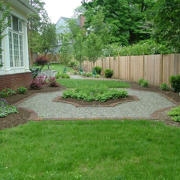 Garden fountain with landscaping shortly after planting