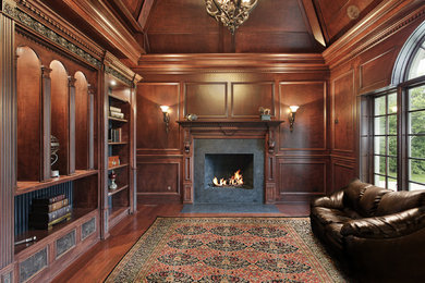 Inspiration for a mid-sized timeless medium tone wood floor home theater remodel in DC Metro with brown walls