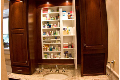 Inspiration for a mid-sized timeless master travertine floor bathroom remodel in Philadelphia with raised-panel cabinets, dark wood cabinets, a two-piece toilet, beige walls, an undermount sink and granite countertops