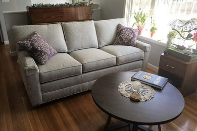Living room - small transitional formal and open concept medium tone wood floor and brown floor living room idea in Boston with gray walls, a standard fireplace, a brick fireplace and no tv