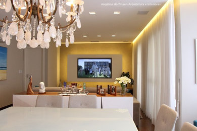 Example of a mid-sized trendy open concept dark wood floor and brown floor living room design in Other with beige walls and a media wall