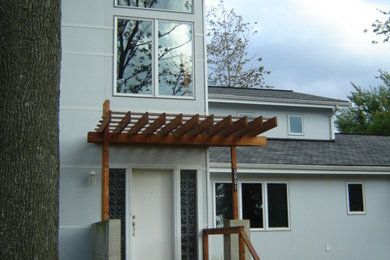 Mid-sized trendy gray two-story concrete fiberboard exterior home photo in New York with a shed roof