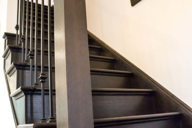 This is an example of a mid-sized wood straight staircase in Toronto with wood risers.