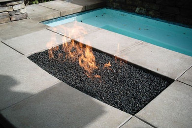 This is an example of a contemporary backyard patio in San Francisco with a fire feature and concrete slab.