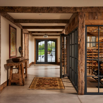 Hand Hewn Timbers and Weathered Antique Paneling in Farmhouse Hallway
