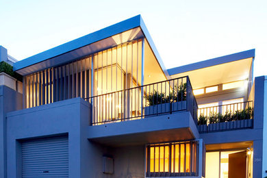Photo of a large contemporary two-storey house exterior in Sydney with mixed siding and a flat roof.