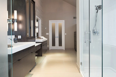 Inspiration for a mid-sized master brown tile and ceramic tile ceramic tile corner shower remodel in Kansas City with flat-panel cabinets, dark wood cabinets, brown walls and an undermount sink