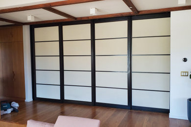 Huge danish medium tone wood floor living room photo in Los Angeles with a music area