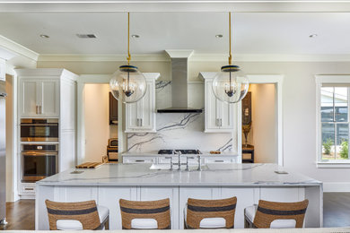 Large transitional medium tone wood floor and brown floor open concept kitchen photo in Other with a farmhouse sink, white cabinets, quartz countertops, white backsplash, quartz backsplash, stainless steel appliances, an island, white countertops and beaded inset cabinets