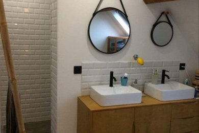 Small urban ensuite bathroom in Other with flat-panel cabinets, beige cabinets, a submerged bath, beige tiles, ceramic tiles, beige walls, light hardwood flooring, double sinks, a freestanding vanity unit and a timber clad ceiling.